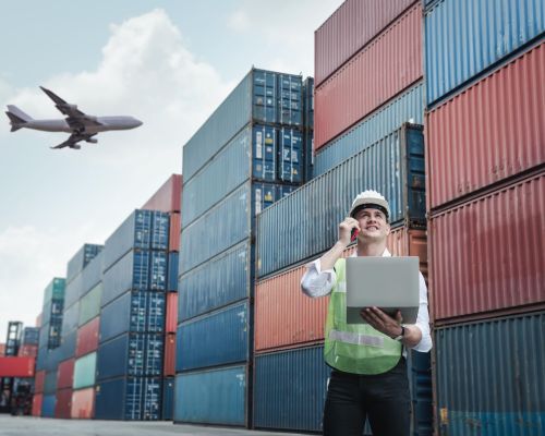 low-angle-view-man-standing-against-buildings-min